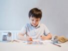Kid using colour pen drawing and painting on paper, Child colouring dog toys on paper,